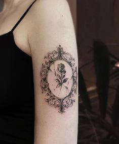 a woman's arm with a clock and rose tattoo on it