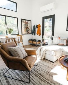 a living room filled with furniture and lots of windows