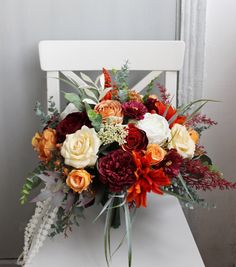 a bouquet of flowers sitting on top of a white chair