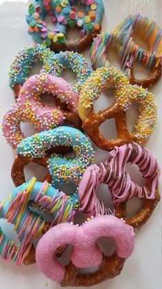 a bunch of doughnuts with sprinkles and frosting on them