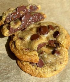 two chocolate chip cookies sitting on top of each other