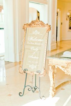 a sign that says welcome to the bride and groom on it in front of a table