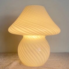 a white lamp sitting on top of a table