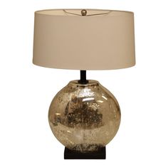 a glass table lamp with a white shade on the base and a black wooden base