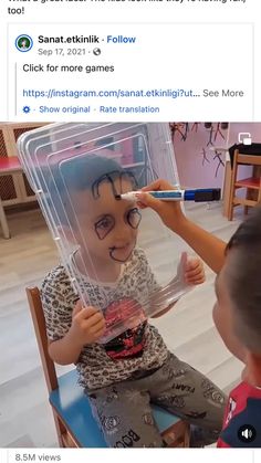 two children sitting in chairs with fake faces on them