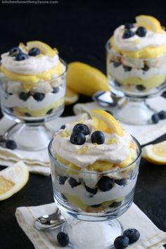 lemon and blueberry trifle with whipped cream in small glass dishes on napkins