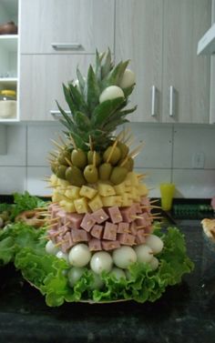 a pineapple and other fruits are stacked on top of each other in the kitchen