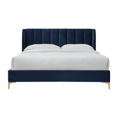 a bed with blue velvet headboard and white linens on the bottom, in front of a white background