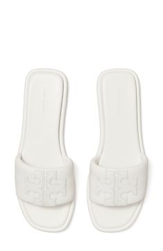 A sleek leather slide accented by Tory's signature double-T logo is ready to upgrade your warm-weather style. Leather upper and lining/rubber sole Imported White Tory Burch Sandals, Tory Burch Slides, Golden Shoes, Minimalist Sneakers, Vacation Shoes, Pretty Sandals, Tory Burch Sandals, White Sandals, Designer Sandals