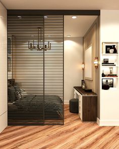 a bedroom with wooden flooring and sliding glass doors that lead to a bed area