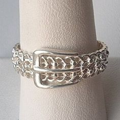 SIZE: 10.25  WIDTH: 8.5 mm  BEATIFUL GIFT BOX INCLUDED   Add a touch of vintage beauty to your wardrobe with this Filigree Estate Belt Buckle Garter Band Ring in size 10.25. Crafted from 925 sterling silver, this ring features a intricate filigree design and a classic band style. The ring does not have a stone and is perfect for those who appreciate the beauty of sterling silver.  This ring is perfect for those who love vintage jewelry and want to add a unique piece to their collection. The ring Buckle Ring, Filigree Design, Size 10 Rings, Vintage Beauty, Belt Buckle, Band Ring, Belt Buckles, Band Rings, Unique Pieces