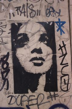 graffiti on the side of a wall with a woman's face