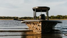 a small boat is in the water with trees in the background