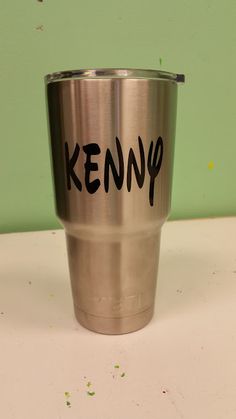 a stainless steel cup with the word kenny written on it