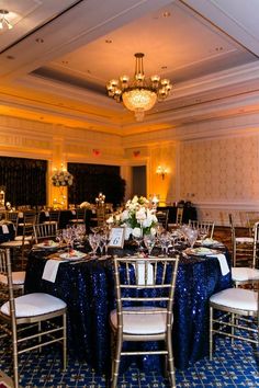 a banquet room set up with blue and white table cloths