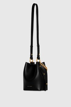 Not your average bucket bag, the Kate Small Bucket is crafted from genuine leather and gives you all the strap options. Carry it effortlessly by the chain top handle, by its long strap over your shoulder, or as a crossbody. Style# CF24TKAUSM 100% Genuine Leather Antique Brass Hardware 10. 5"W X 8. 5"H X 4. 5"D Detachable Strap - Strap Drop 19. 5" Chain strap Snap Closure Imported The photos featuring a model are for size reference only. Actual color and material may vary from what is depicted. | Formal Bucket Bag With Metal Hardware, Modern Bucket Bag With Branded Hardware For Daily Use, Modern Bucket Bag With Metal Hardware For Evening, Elegant Bucket Bag With Metal Hardware, Modern Evening Bucket Bag With Branded Hardware, Modern Evening Bucket Bag With Metal Hardware, Bucket Shoulder Bag With Branded Hardware, Leather Crossbody Bucket Bag With Branded Hardware, Modern Crossbody Bucket Bag With Metal Hardware