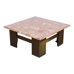 a pink marble top coffee table with metal legs and square base on an isolated white background