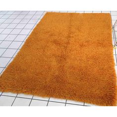 an orange shaggy rug on the floor