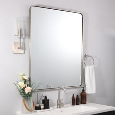 a bathroom sink with a large mirror above it