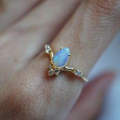 Elegant, intricate—one of our favorite curved silhouette. Featuring a dreamy opal in pear shape with tiny CZs twinkling under the sunlight. Create a deity stack by pairing it with our Goddess ring band. This ring is designed and handmade in NYC. Available in your choice of yellow gold, rose gold, silver, or 14K solid gold. Gold vermeil or 14K Solid gold Natural Australian Opal Round CZs (what's this?) ** This item is specially made for you. Please allow 1-2 week lead time. ShippingDomestic: Free Goddess Ring, Twig Ring, Tiny Diamond, Australian Opal, Ring Band, Opal Rings, Pear Shape, 10k Gold, Gold Vermeil