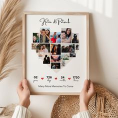 a person holding up a framed photo with the names of their wedding day and date