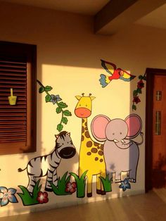 a wall with animals painted on it in front of a door and window sill