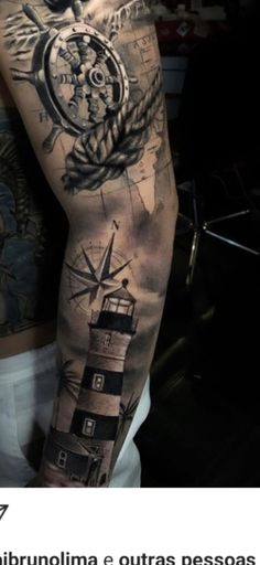 a man's arm with a lighthouse and compass tattoo on it