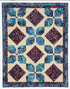 a blue and purple quilt with swirls on it