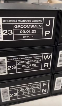 four black boxes are stacked on top of each other, labeled with the names of groomsmen