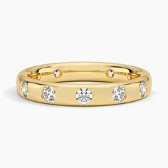 a yellow gold ring with four diamonds