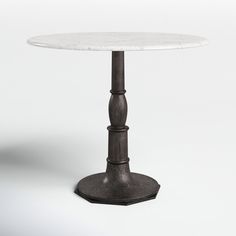 a white marble table sitting on top of a metal base