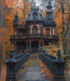 an old house in the woods with autumn leaves on the ground and trees around it