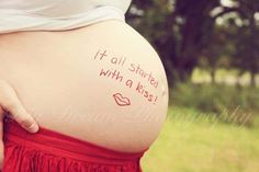 a pregnant woman's belly with writing on it