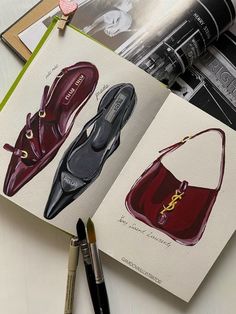 an open book with pictures of shoes and purses on it next to a pen