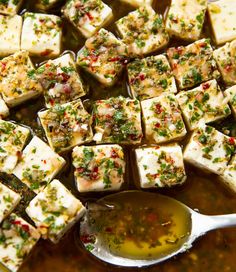 tofu cubes with herbs and oil in a pan