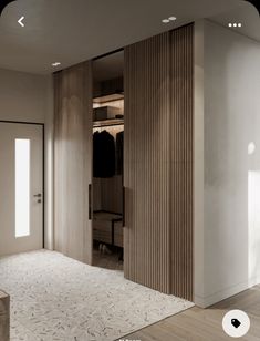 an open closet with clothes hanging on the walls and sliding doors in front of it