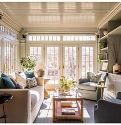 a living room filled with furniture and lots of windows