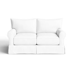 a white couch sitting on top of a white floor