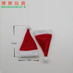 a red and white santa claus hat on top of a table next to a ruler