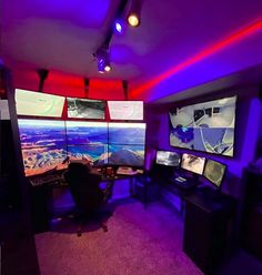 a room filled with multiple computer monitors sitting on top of desks