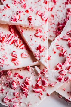 white chocolate with candy canes and sprinkles on top, sitting on a plate