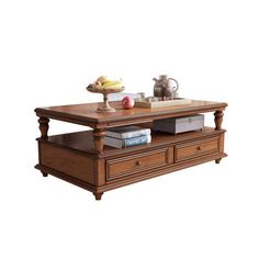 a coffee table with two drawers and a tray on top that has books, teapots and other items on it