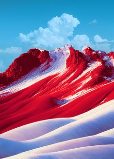 red and white sand dunes with mountains in the background