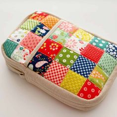 a colorful patchwork case sitting on top of a white table