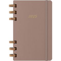 a pink notebook with gold lettering and corks on the front cover is lined in beige paper