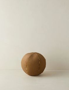 a brown vase sitting on top of a white table