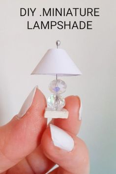 someone holding a miniature lamp in their hand with the words diy miniatureture lampshade on it