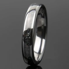 a wedding ring with black and white diamonds