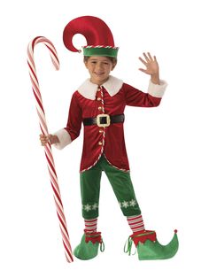 a young boy dressed as santa clause holding a candy cane and wearing an elf costume