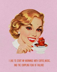 a woman holding a coffee cup with a red cat on the plate in front of her